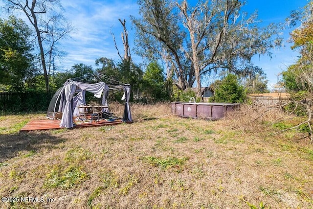 view of yard with a fenced in pool