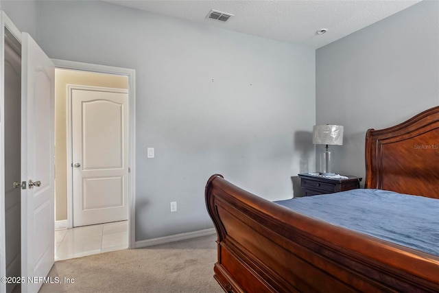 carpeted bedroom featuring a textured ceiling