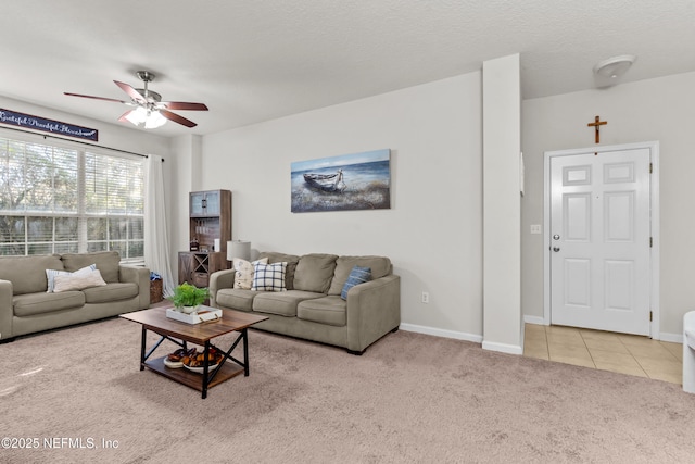 carpeted living room with a textured ceiling and ceiling fan