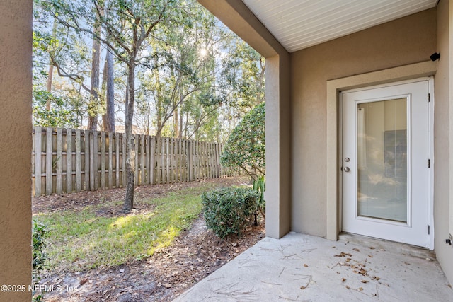 property entrance featuring a patio