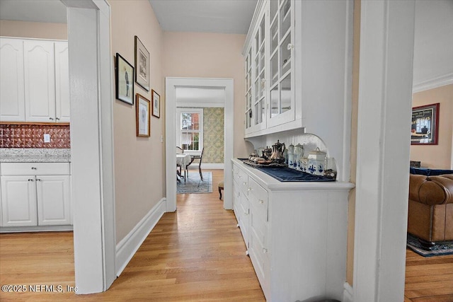 hall with light hardwood / wood-style floors