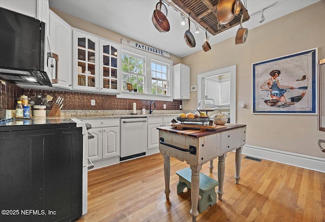 kitchen with range with electric stovetop, dishwasher, white cabinets, and light hardwood / wood-style floors