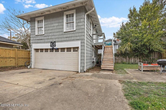 view of front of house featuring cooling unit and a garage