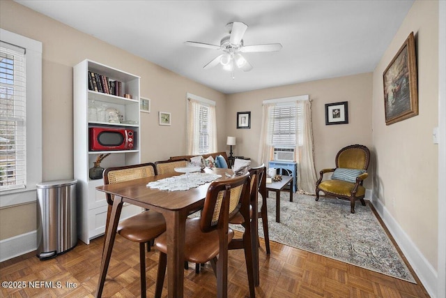 dining space featuring parquet floors and ceiling fan