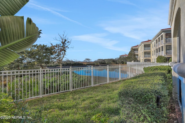 view of pool with a yard