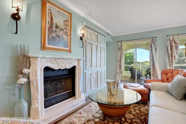 sitting room featuring a premium fireplace, wood-type flooring, and crown molding