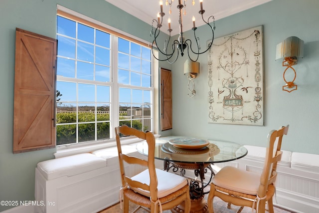 dining area featuring crown molding and a notable chandelier