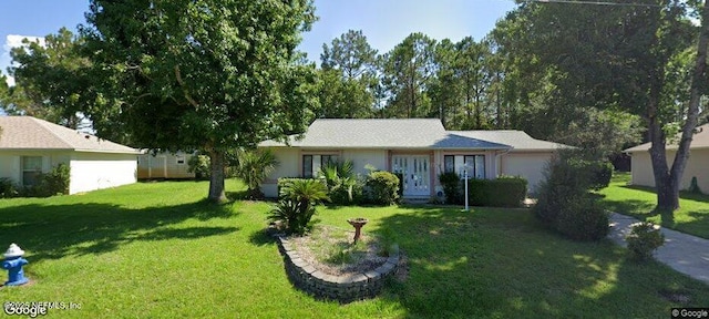 ranch-style home with a garage and a front yard