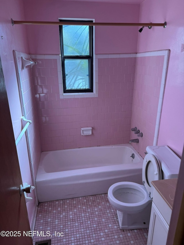 full bathroom with tiled shower / bath, vanity, toilet, and tile patterned flooring