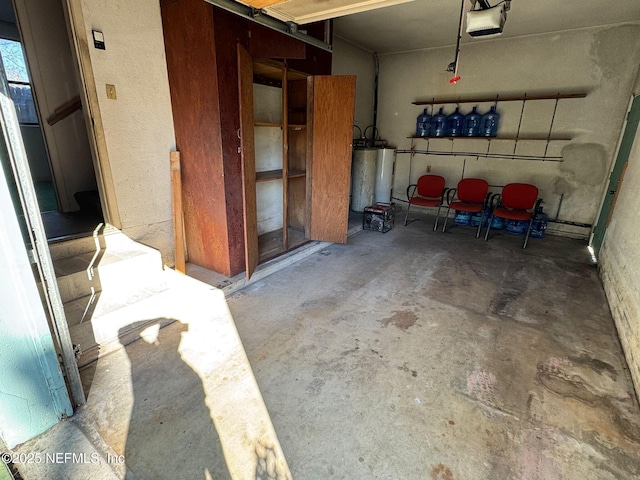 garage featuring water heater and a garage door opener