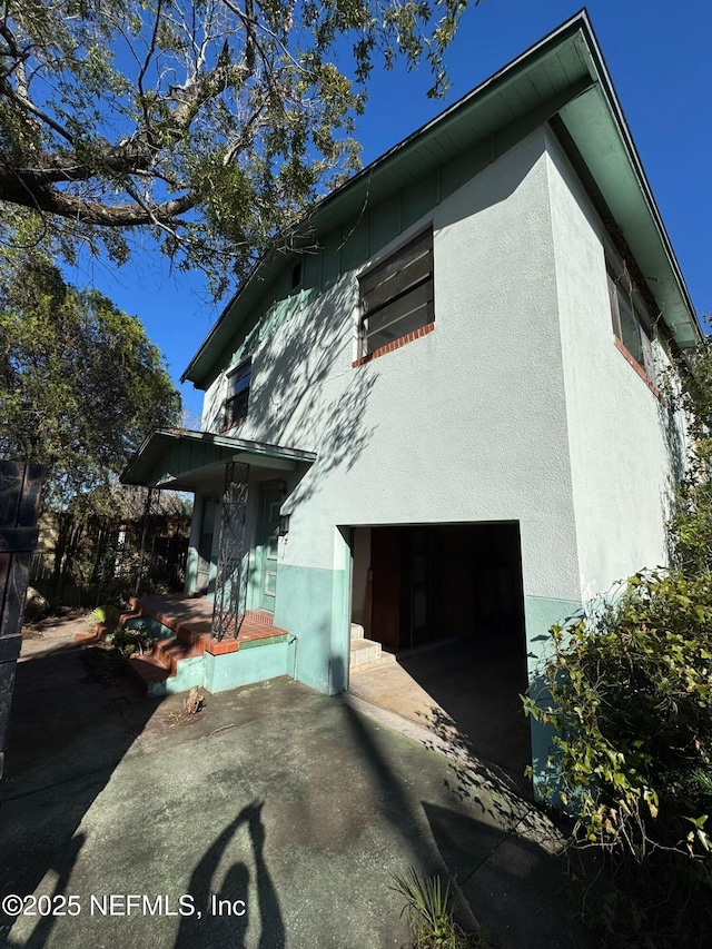 view of side of home with a garage