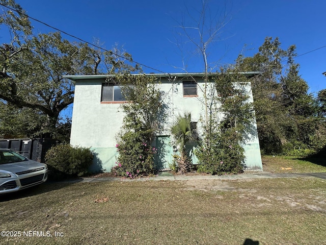 view of side of property with a lawn