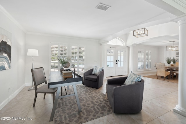 living room featuring ornamental molding, plenty of natural light, and decorative columns