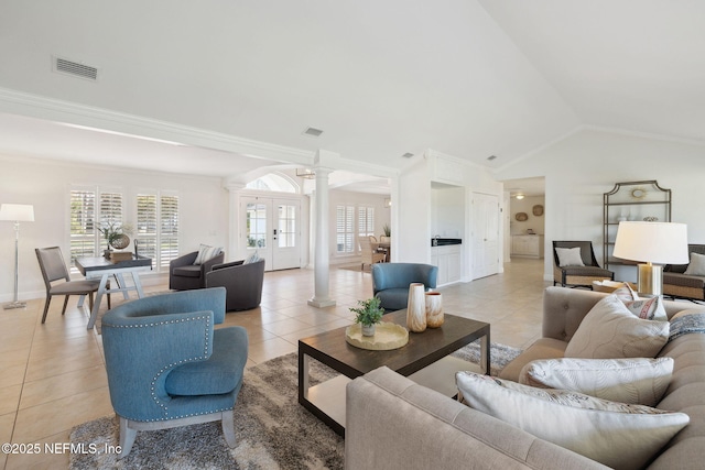 tiled living room featuring lofted ceiling, a wealth of natural light, and ornate columns