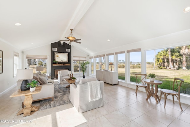 tiled living room featuring ceiling fan, a fireplace, lofted ceiling with beams, and a healthy amount of sunlight