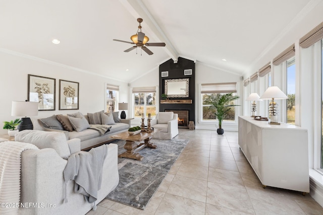 living room with a large fireplace, plenty of natural light, lofted ceiling with beams, and light tile patterned floors