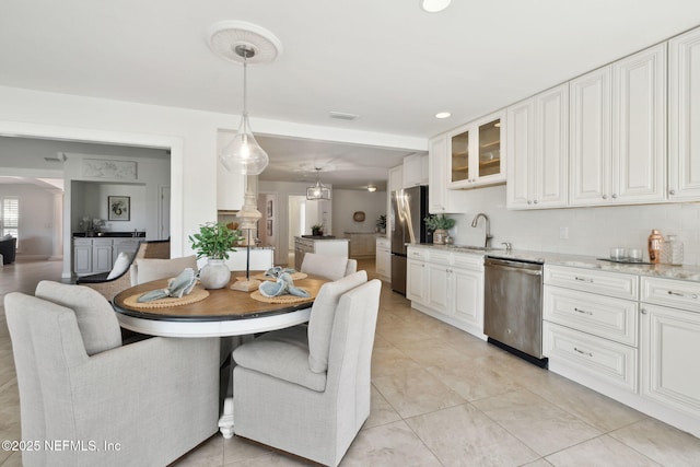 tiled dining room featuring sink