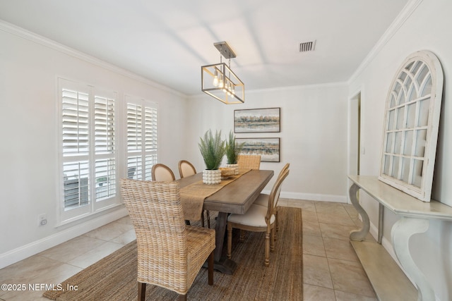 dining room featuring ornamental molding, light tile patterned floors, and a chandelier