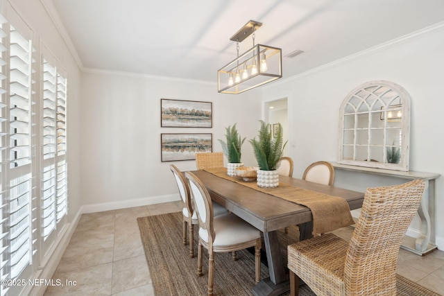 tiled dining room featuring crown molding, plenty of natural light, and a notable chandelier