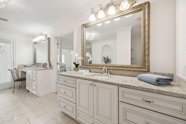 bathroom with crown molding, vanity, and tile patterned flooring