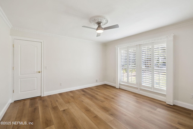 spare room featuring crown molding, ceiling fan, and light hardwood / wood-style floors