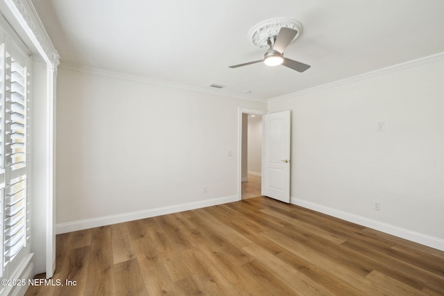 unfurnished room with crown molding, hardwood / wood-style flooring, and ceiling fan