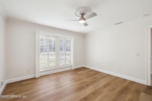 empty room featuring ornamental molding, light hardwood / wood-style floors, and ceiling fan