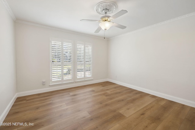 spare room featuring crown molding, ceiling fan, and light wood-type flooring