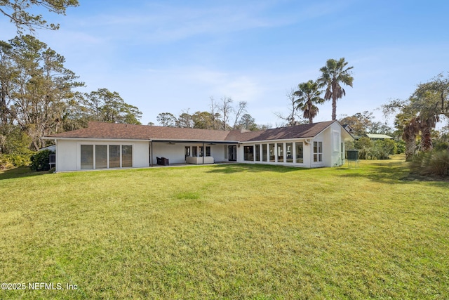 rear view of house with a lawn