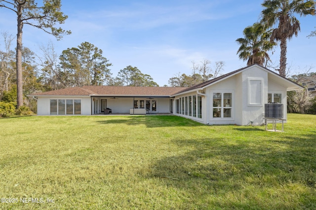 rear view of property with a yard