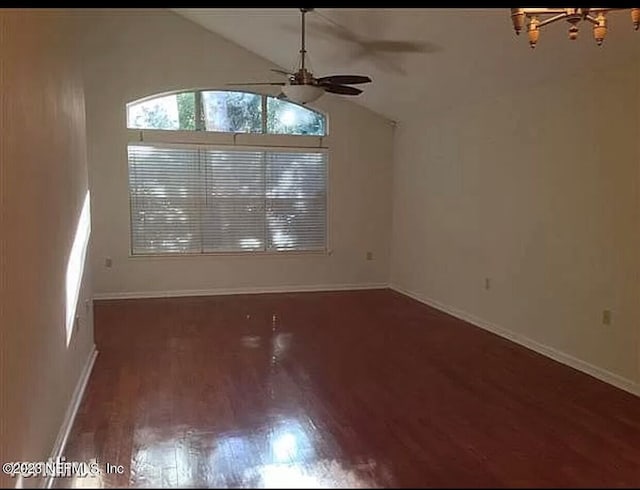 unfurnished dining area featuring dark wood-type flooring, ceiling fan, and vaulted ceiling