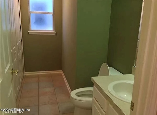 bathroom featuring vanity, tile patterned floors, and toilet