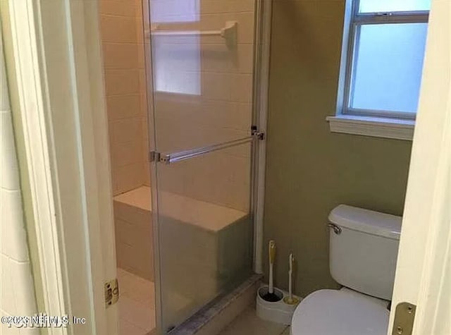 bathroom featuring toilet and walk in shower