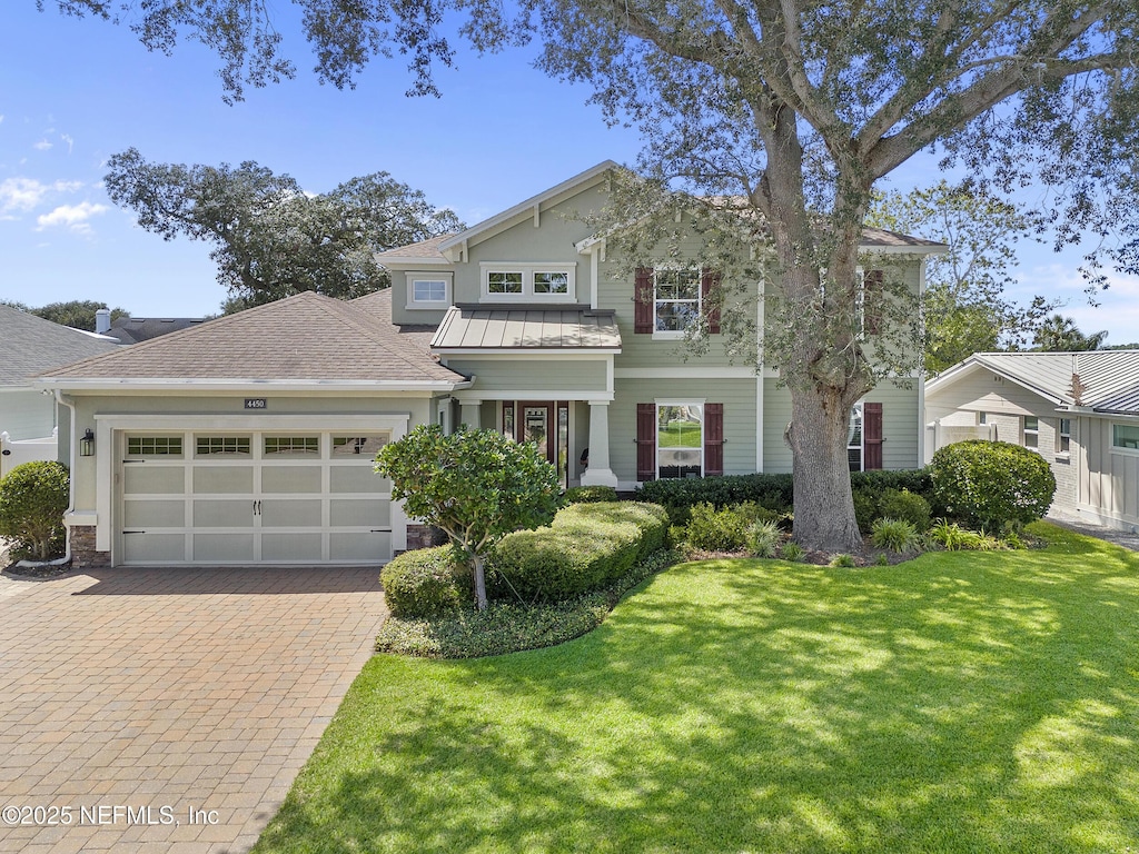 view of front facade with a garage and a front lawn