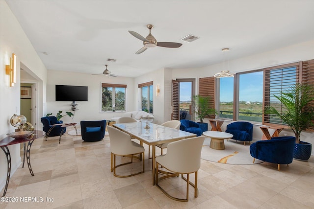 dining room featuring ceiling fan and a healthy amount of sunlight