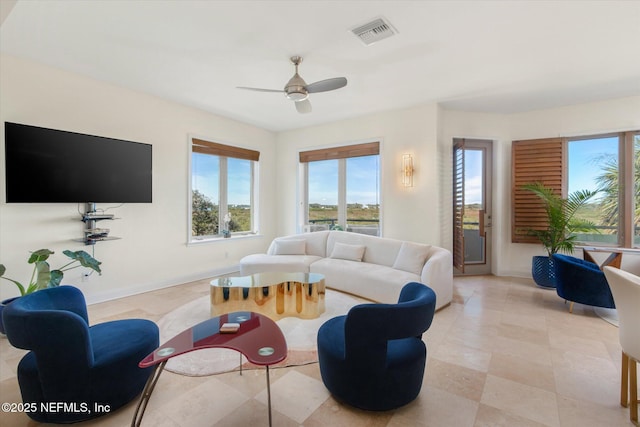 living room featuring ceiling fan and plenty of natural light