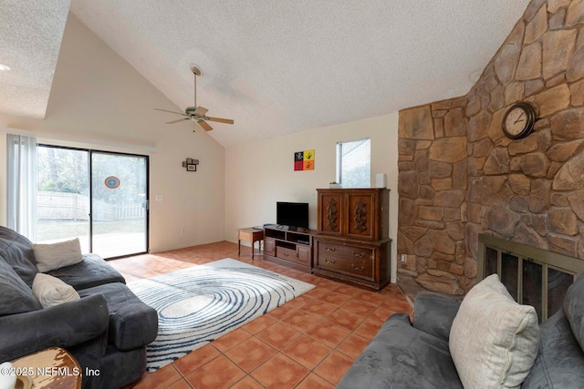 living room with light tile patterned floors, a stone fireplace, a textured ceiling, and ceiling fan