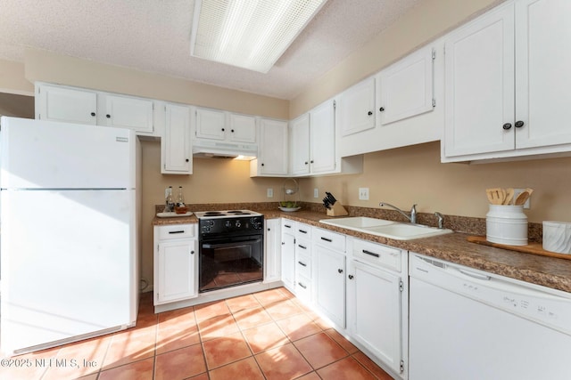 kitchen featuring light tile patterned floors, white cabinetry, a sink, white appliances, and under cabinet range hood