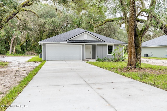 single story home featuring a garage and central AC