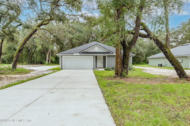 ranch-style home featuring a garage and a front lawn