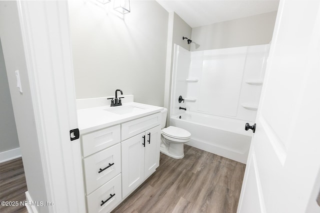 full bathroom featuring vanity, shower / washtub combination, hardwood / wood-style floors, and toilet