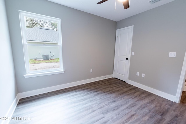 empty room featuring dark wood-type flooring and ceiling fan