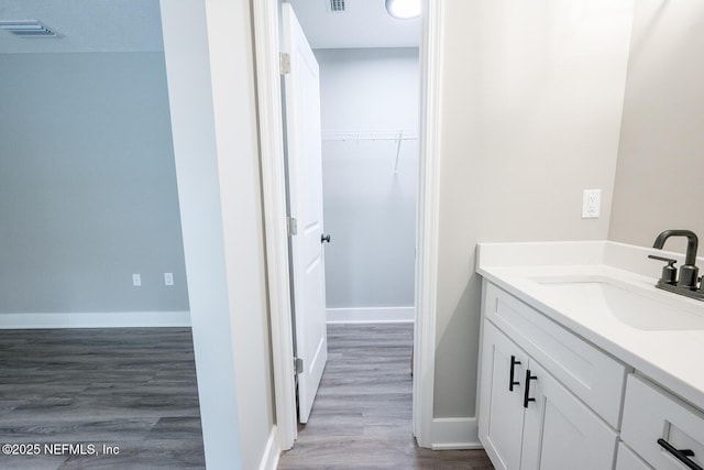 bathroom with vanity and hardwood / wood-style floors