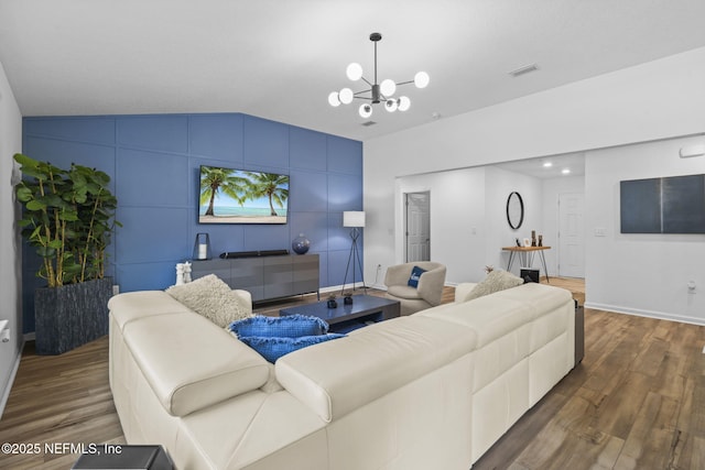 living room with lofted ceiling, a notable chandelier, and dark hardwood / wood-style floors