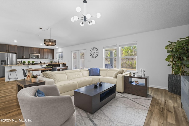 living room featuring dark hardwood / wood-style floors, sink, and a textured ceiling