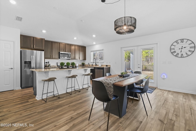 dining room with hardwood / wood-style flooring and french doors