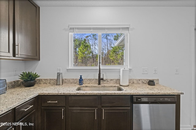 kitchen with sink, dark brown cabinets, light stone countertops, and dishwasher