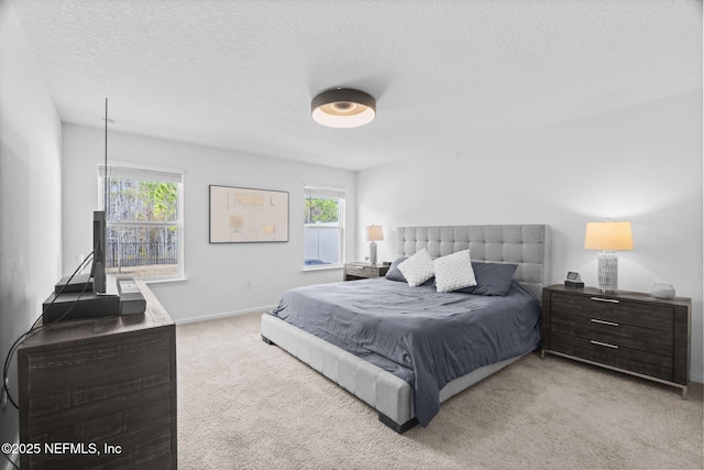 bedroom with light carpet and a textured ceiling