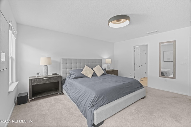 bedroom with carpet and a textured ceiling