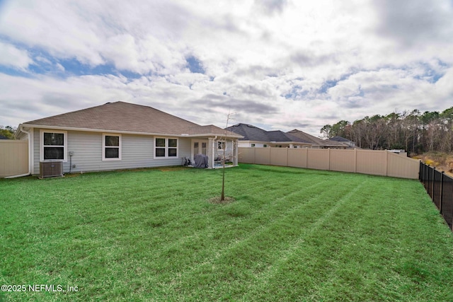 rear view of property with a yard